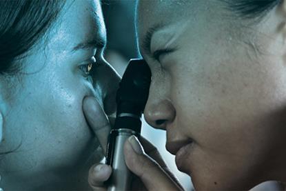Optometrist doctor patient eye exam examination small